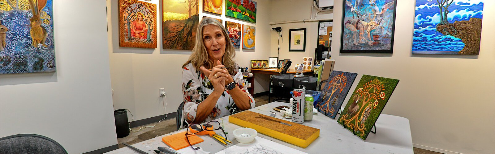  Visual artist Denise Cormier Mahoney works on a new art piece as she welcomes visitors at her studio during the Second Saturday ArtWalk in the Warehouse Arts District.