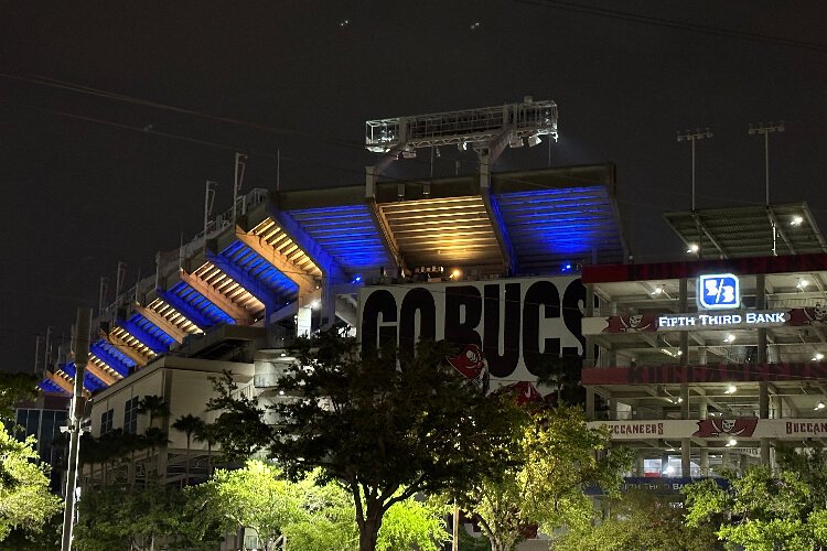 Raymond James Stadium, home of the red and pewter Bucs, is illuminated blue and yellow for World Down Syndrome Day.