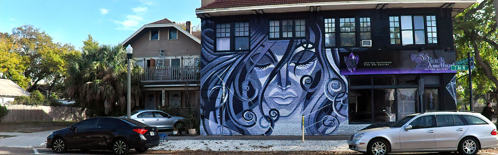 Designed by J. Michael Taylor, the owner of St Pete’s Black Amethyst Tattoo Gallery, the “Purple Lady” mural was painted on the sidewall of his business by Vitale Bros.