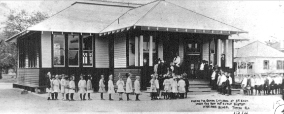 Boys and girls lined up in 1914 outside lunch room at Gorrie Elementary for first hot lunch served at Tampa school.