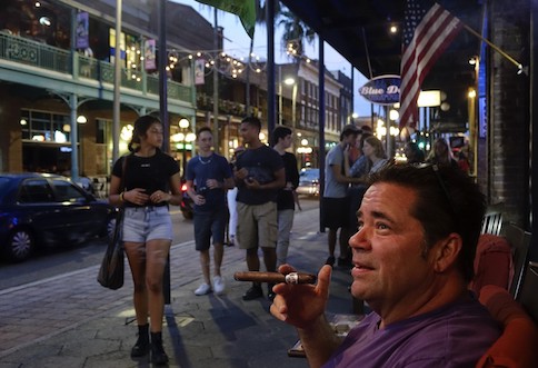 Gary Russo smokes a cigar in front of Taberno Cigars
