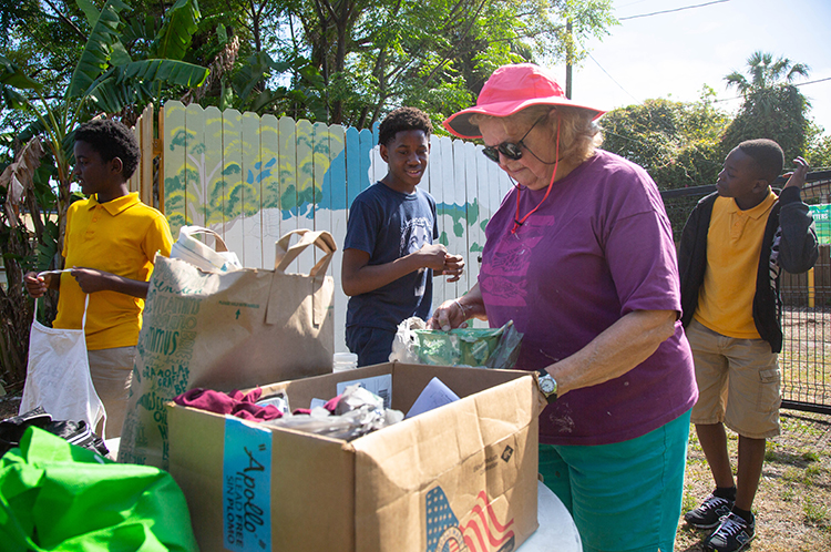 Beverly Owen, a retired art teacher, leads to mural painting project with after-school program teens in Tampa Heights.