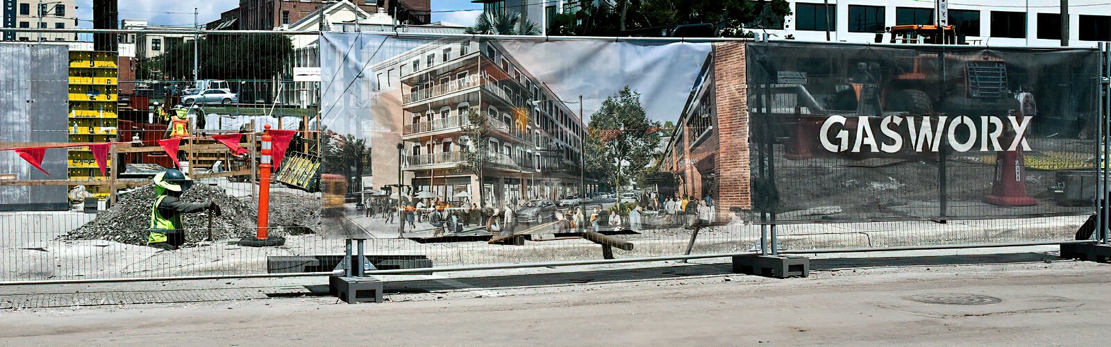 A banner on the construction fencing at Gasworx has a rendering of what the residential building going up behind the fence will look like when finished