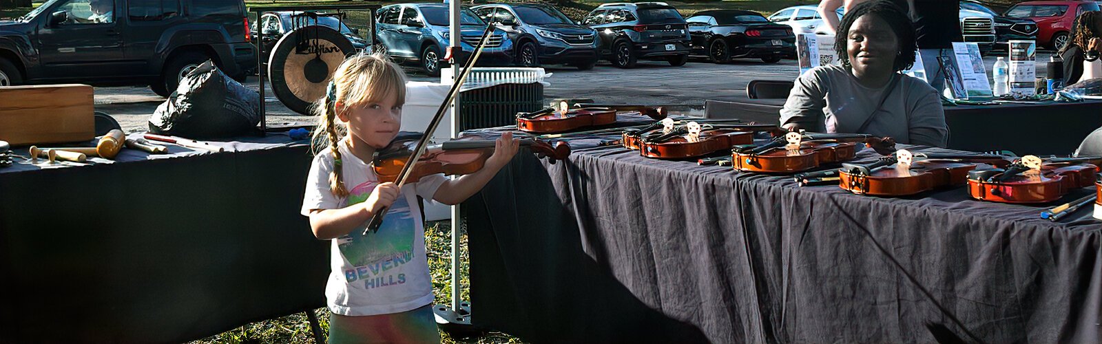 Elizabeth, 4, is one step closer to her dream at The Florida Orchestra’s instrument petting zoo, staffed by volunteers from Big Brothers Big Sisters of Tampa Bay.