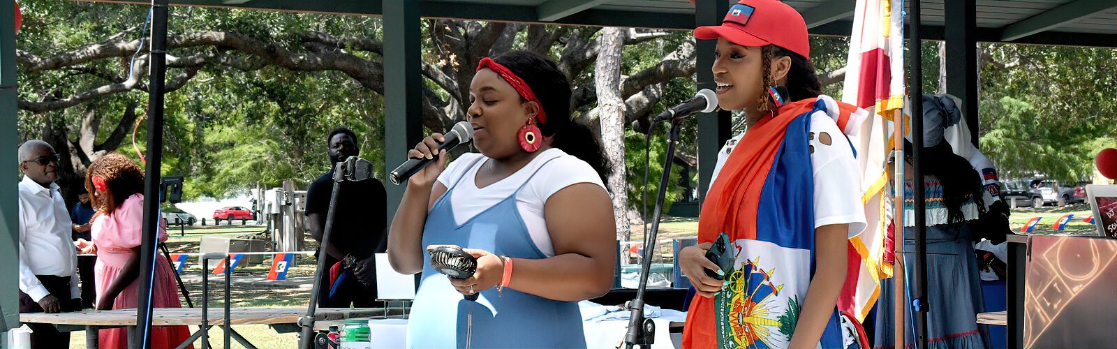 Darby Dieudonne and Rachel Pierre entertain the audience with traditional Haitian songs at the Tampa Bay Haitian Flag Day festival.