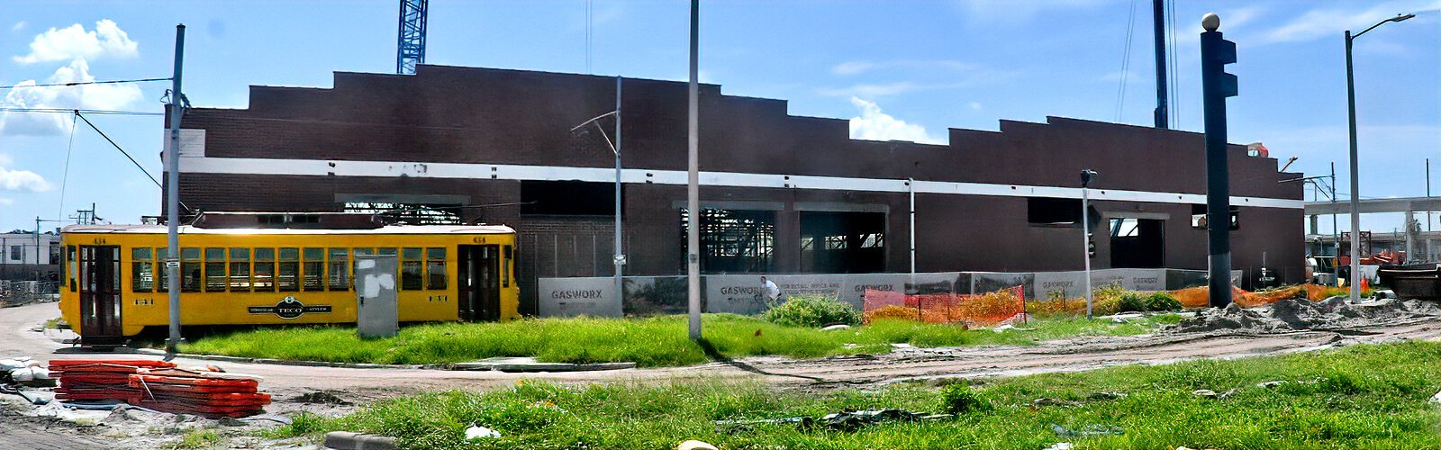 A TECO streetcar passes in front of an old warehouse being repurposed into a marketplace as part of the Gasworx project. The streetcar will add a new stop near the marketplace.