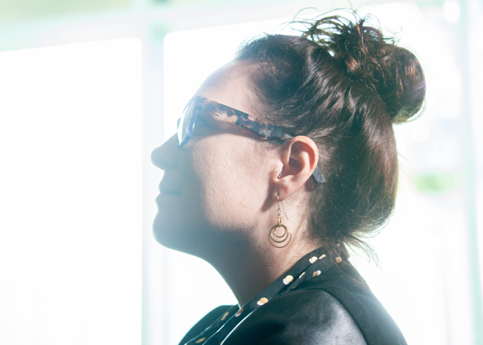 A woman listens to speakers at Synapse.