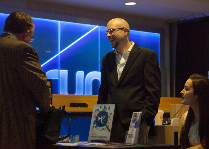 Sameer Mohammad, left, of USF and Kathryn Donadio of Modern Consulting 360 talk with guests at Synapse.