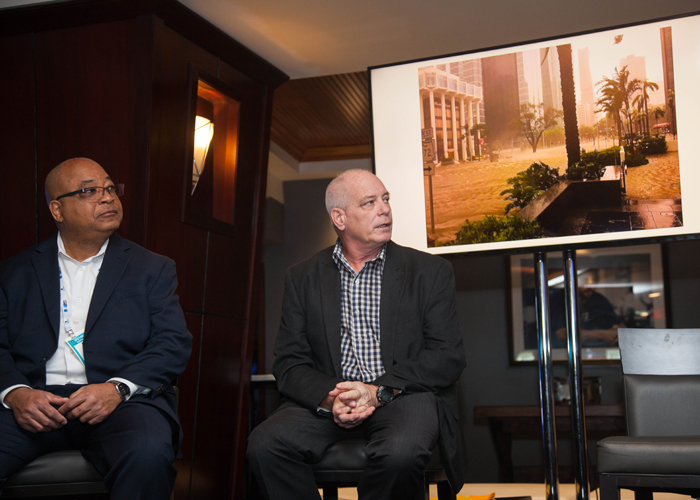 Charles Randatt, left, listens as Kevin Burns speaks on Miami's sea level rise issues at Synapse Summit.