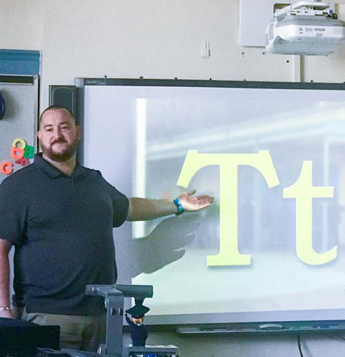 Michael Glenn goes over the alphabet with new students.