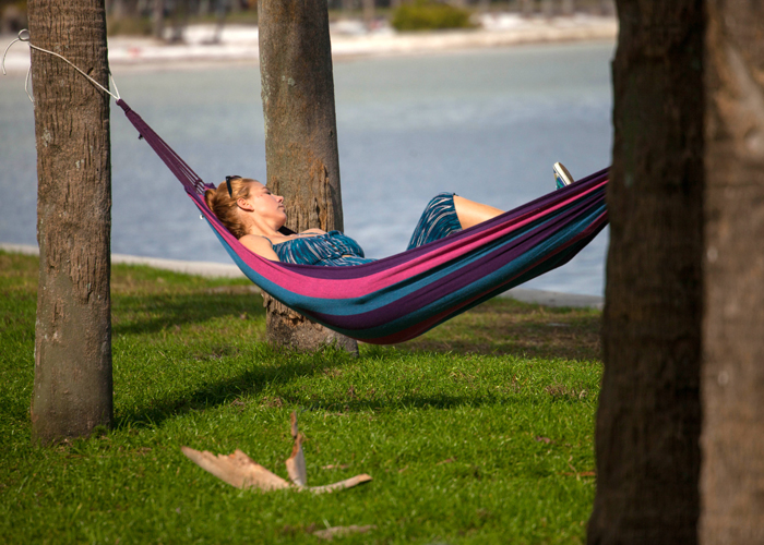 A woman relaxes on a hammock along St. Pete's waterfront.
