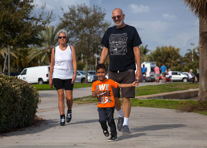 A family passes the North Shore Aquatic Complex in St. Pete.