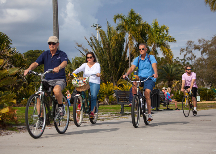 Cyclists along the boardwalk near the palm tree botanical gardens at Vinoy Park in St. Pete.