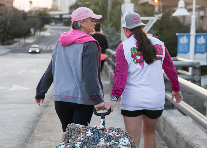 Sylvia Campbell, a breast cancer surgeon, and her daughter Meaghan Hoy pull a wagon of mats made from tied plastic bags to provide insulation from the ground.