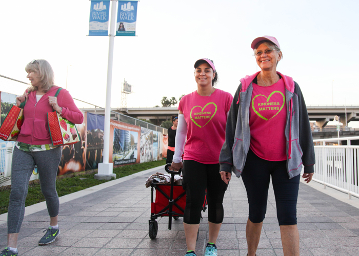 (L-R) Gia Metcalf, left, Maribell Figueroa, a breast cancer survivor, and Sylvia Campbell, a breast cancer surgeon, help feed Tampa's homeless in the early morning hours. 