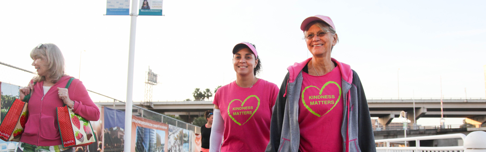 (L-R) Gia Metcalf, Maribell Figueroa, a breast cancer survivor, and Sylvia Campbell, a breast cancer surgeon, help feed Tampa's homeless. 