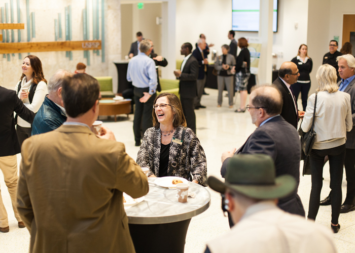 Attendees at the first Sunny Side Up forum wait in the lobby of Lynn Pippenger Hall at the USFSP College of Business.