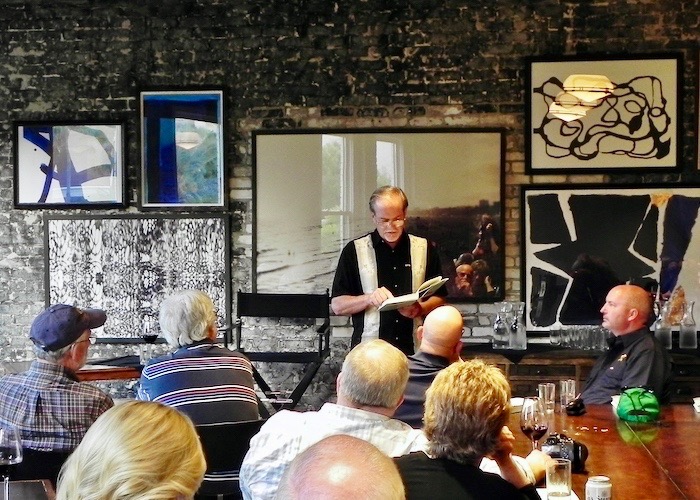 Author Robert Macomber reads aloud at a pre-launch book party at Oxford Exchange in Tampa.