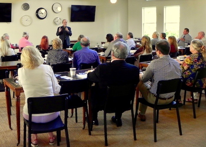 Author Robert Macomber tells Cafe con Tampa patrons about his new novel, 'Honoring the Enemy.'