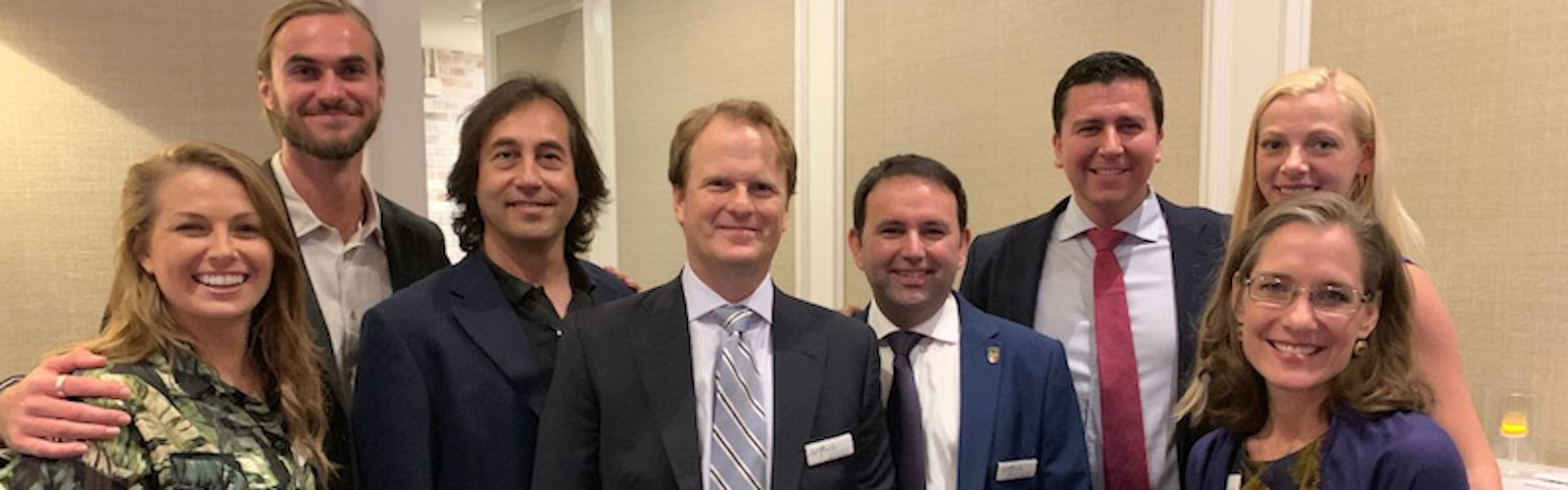 La Florida Executive Director J. Michael Francis (gray striped tie) surrounded by his research team.