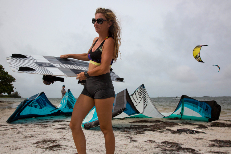 Rebecca Wilcox carries her board in after an early morning kite surf session.