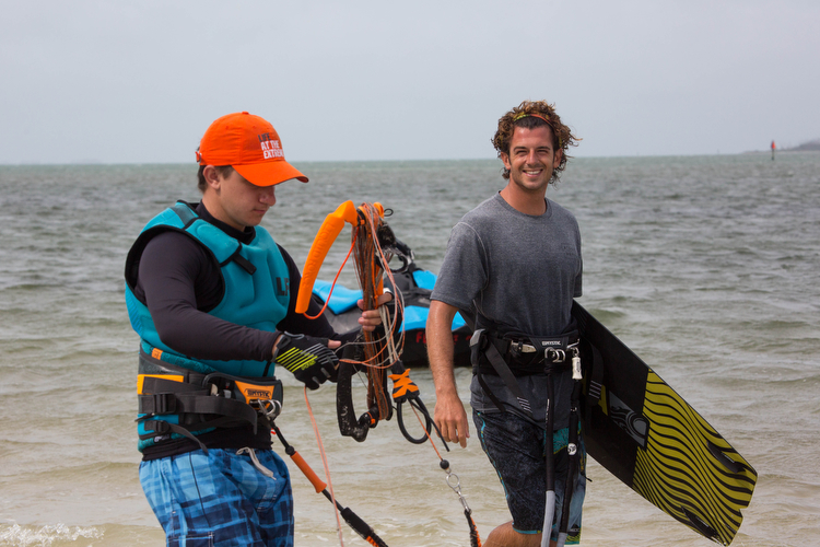 Anthony Franchi, right, with Kiteboarding St. Petersburg walks past a fellow rider.