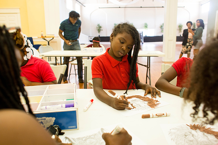 Elementary school kids color during the after-school program.