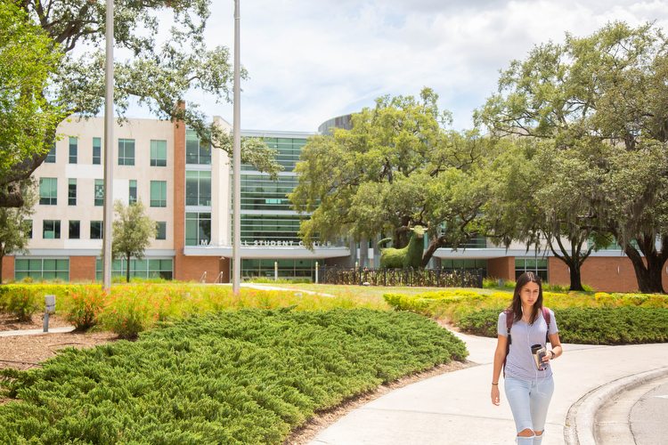 A woman walks outside of Marshall Student Center.