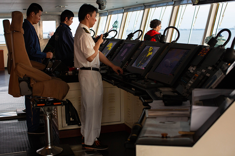 Chinese Ship Captain Yang Yi Jun relays commands from Harbor Pilot Carolyn Kurtz to his crew.