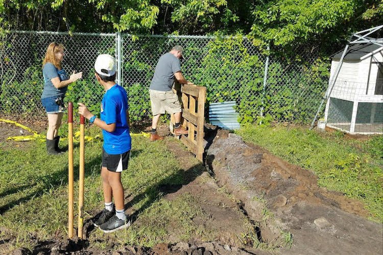 Volunteers build a fence at Walker Middle for a tortoise den.