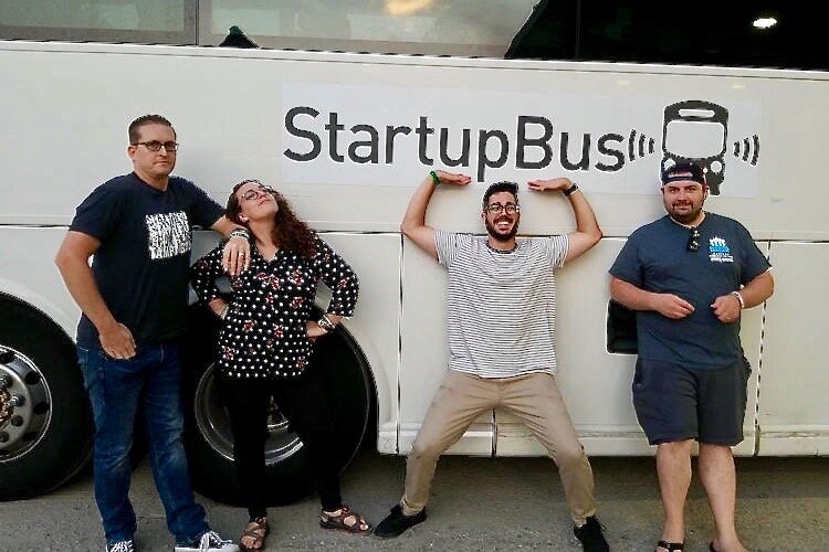 Nick Price, Lead Conductor of StartupBus Florida 2019 (in tan pants), prepares to board the bus with team members. 
