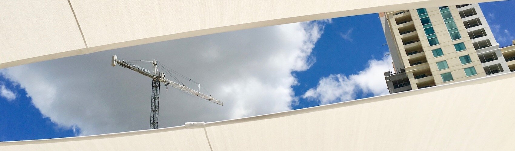 A crane over the J.W. Marriott construction project peeks through the awnings at the new Big Ray's Fish Camp on The Tampa Riverwalk.