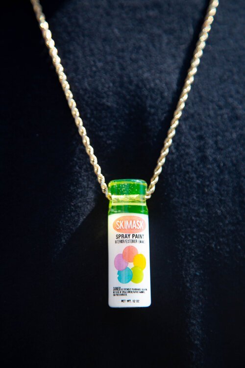 Derek Donnelly wears a necklace honoring mural artist's paint tool, the spray paint can.