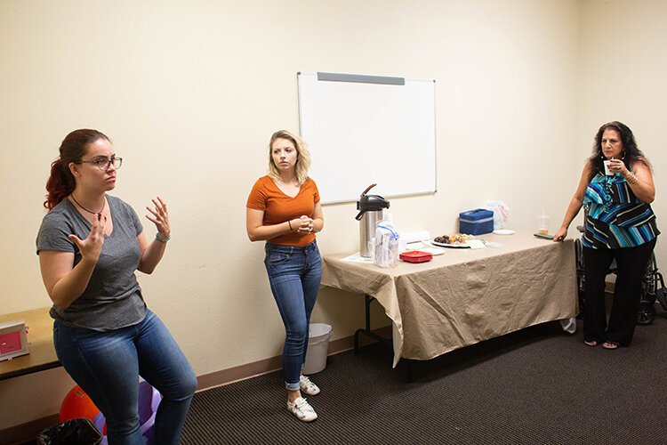 Marina Martinez, left, Danica Dvorachek, and Diane Zweil discuss ways to promote recovery with addicts.