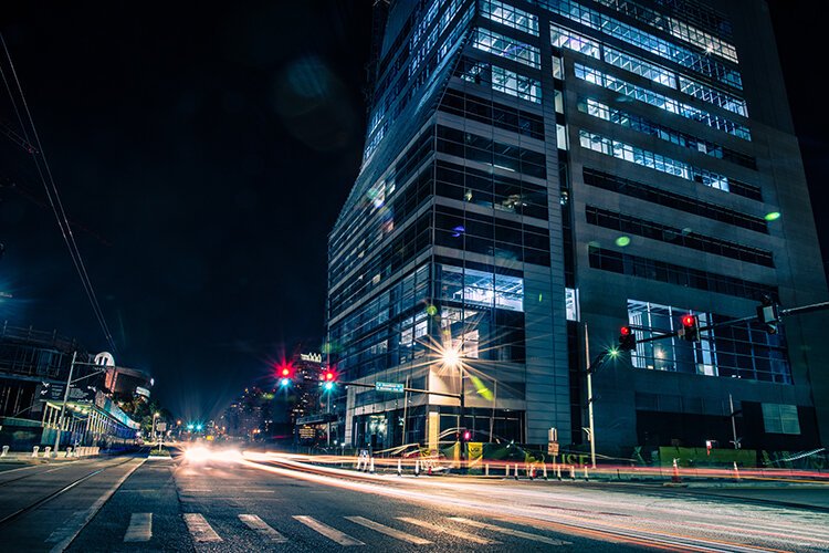 At night the lights of the USF Morsani College of Medicine and Heart Institute shine along Channelside Drive.