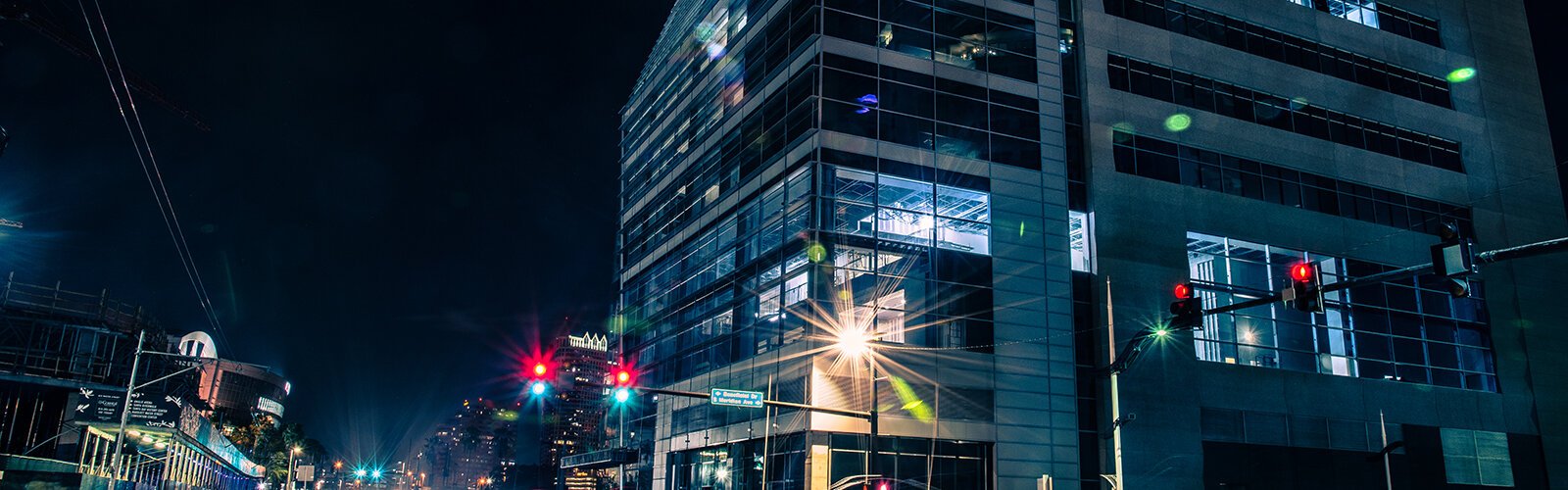 At night the lights of the USF Morsani College of Medicine and Heart Institute shine along Channelside Drive.