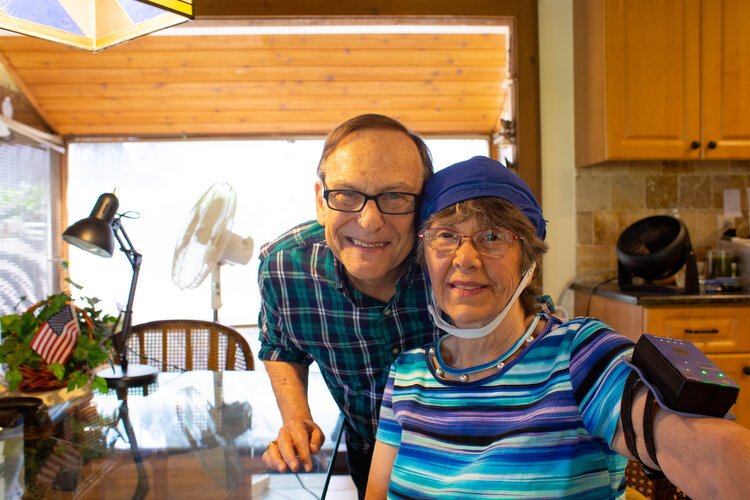 Larry Sizeler helps his wife Janet with her NeuroEM Therapeutics 'brain cap' geared to help reverse memory loss, which she wears for one hour every day.