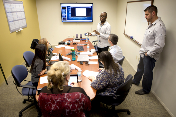 Kristopher Ali presents his team's app to a panel at GTE Financial. 