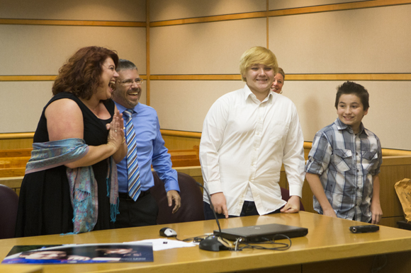 The Kenty family stands before Judge Gross during their adoption hearing. 