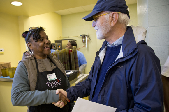 Photographer Tim Kennedy chats with Carmen Cortes, one of his photo subjects, at Trinity Cafe. 