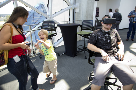 The Curry family checks out the Oculus Rift Virtual Reality Demo during Project34 Hackathon at The Dali.