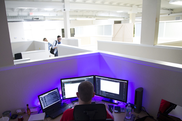 Brett Lee works at his illuminated desk at kitedesk. 