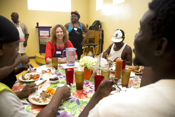 Mandy Cloninger sits and talks with Trinity Cafe guests as they have lunch. 