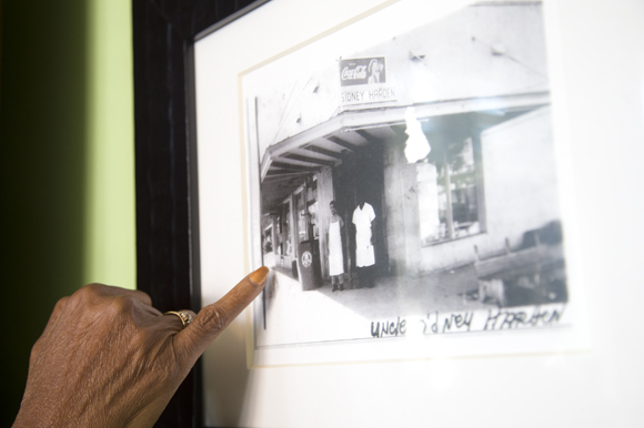 Carolyn Brayboy points to a picture of the Sydney Harden Grocery that is now Chief's Creole Cafe. 