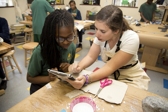 Academy Prep teach Amanda Fleishbein helps Jazmyn Wajd design her entry for the DooDad Competition.   