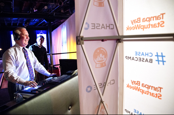 Mayor Bob Buckhorn works the DJ table at Tampa Bay Startup Week.  