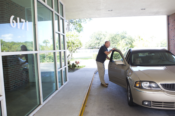Volunteer driver Ken Boyles helps Marilyn Barnes to her doctor's appointment.