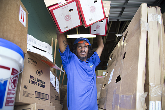 Demetrius Golden, of Youthbuild, prepares to install smoke detectors in a couple of Robles Park homes. 