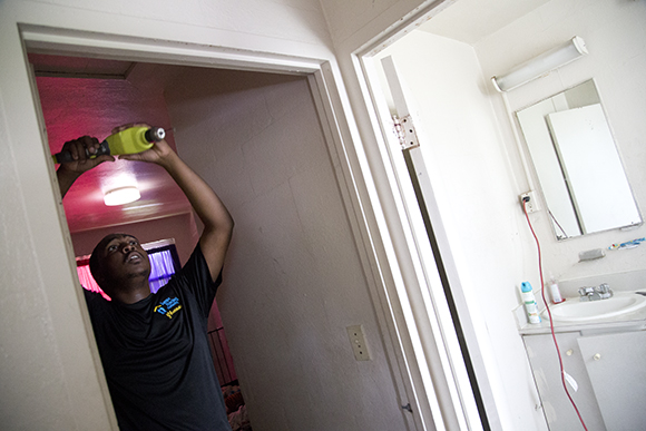 Bryan Taylor installs a smoke detector in a Robles Park home. 
