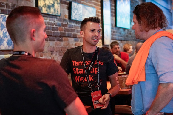 Event Organizer Ryan Sullivan speaks with Ned Pope and Nicholas Catania.